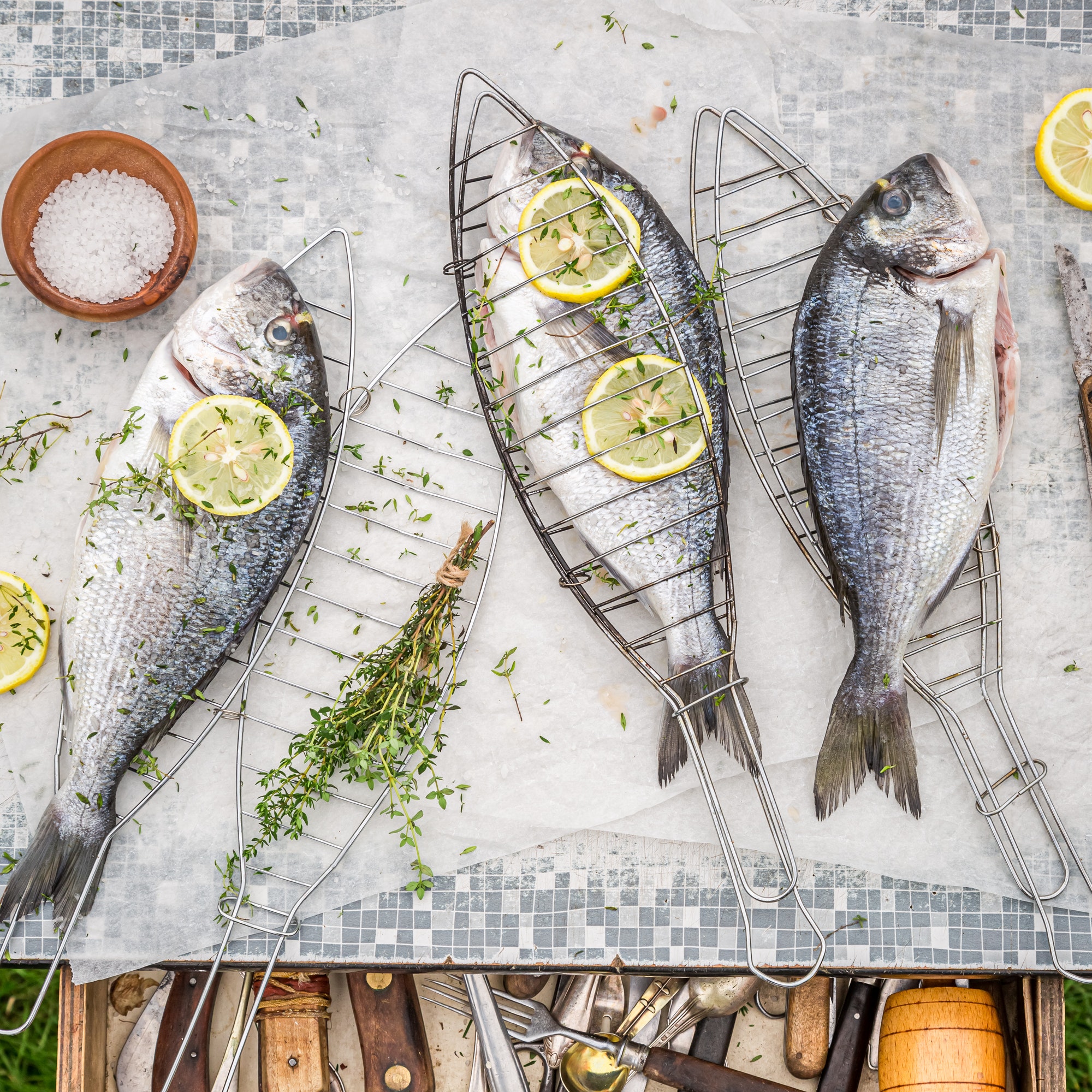 Seasoning freshly caught sea bream with salt and lemon